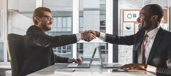 business men shaking hands at meeting